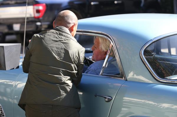 Leno in the driver's seat of a vintage Maserati after the burn accident.