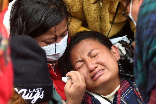 Family members and relatives of victims who died in a Yeti Airlines plane crash, weep outside a hospital in Pokhara.