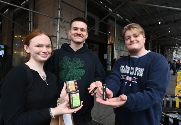 Gabby Wright,21, Christian Katulka,23, and Riley Watkins,22, all from Atlanta, show their prerolls and disposable vape pens they bought at Housing Works Cannabis Co. 