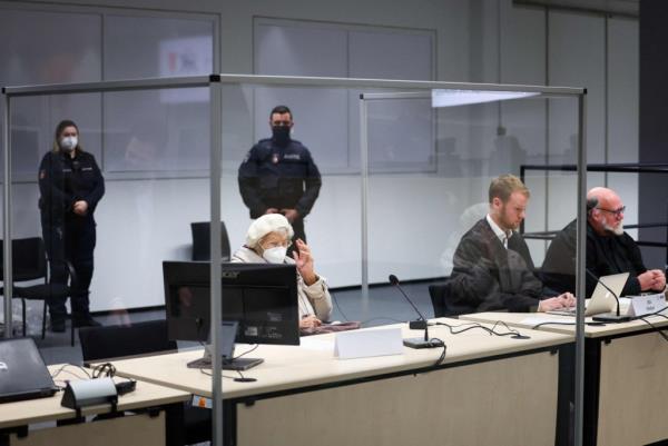 Irmgard Furchner sits close to her lawyers Niklas Weber (2nd R) and Wolf Molkentin (R) in a courtroom in Itzehoe, northern Germany on Dec. 20, 2022. 