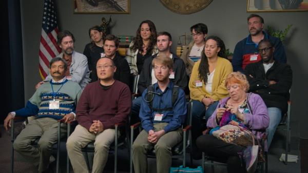 The members of the jury, including James Marsden (center right) and Ro<em></em>nald Gladden (center) sitting in chairs looking bored. 