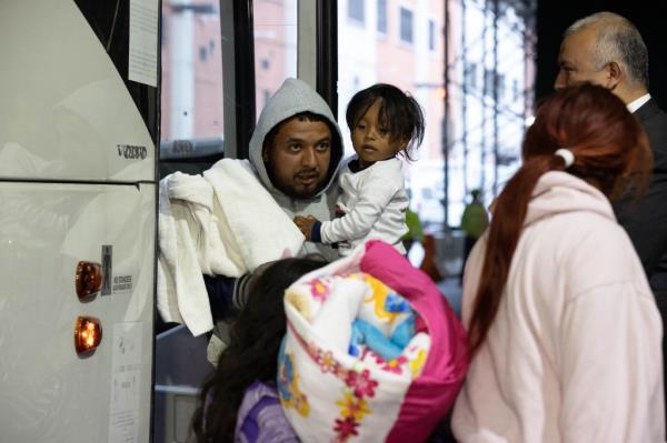 Migrants getting off the bus