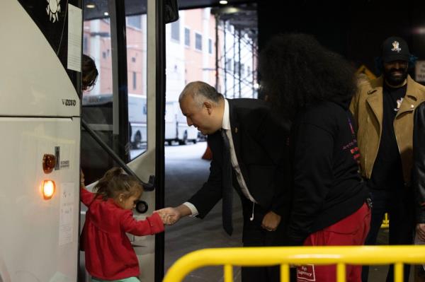 Castro helping a child off of the bus.