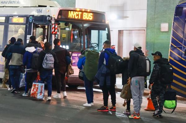 Migrants leaving the Port Authority to go to a shelter.