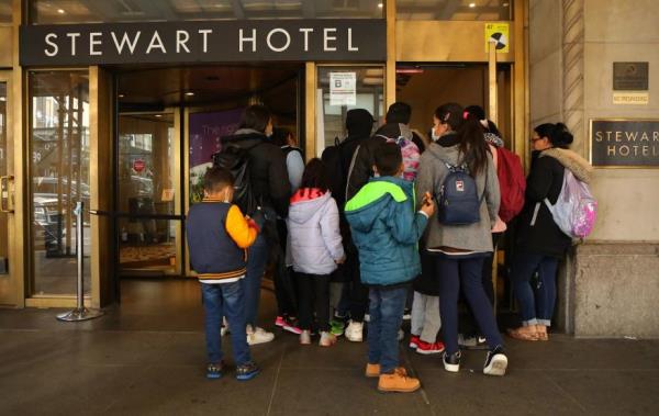 A group of migrants outside of the Stewart Hotel in Manhattan on January 6, 2023.
