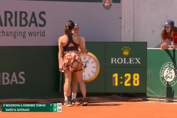 Miyu Kato checking in with the ball girl, who she hit with a ball in between points of the third-round doubles match.