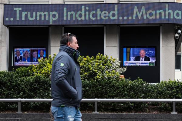 Man walks in front of News Corporation building in midtown Manhattan