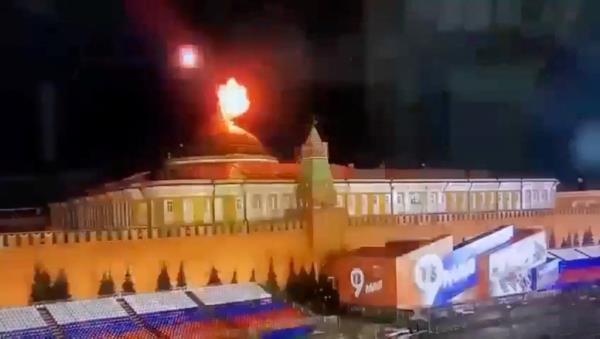 A still image taken from video shows a flying object exploding in an intense burst of light near the dome of the Kremlin Senate building.