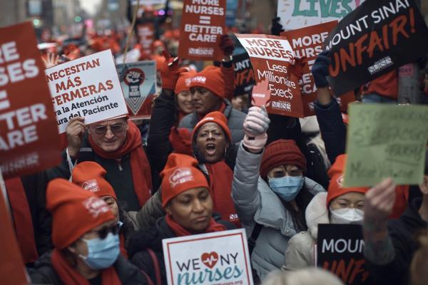 Nurses shout slogans and hold signs during a nursing strike outside Mount Sinai Hospital on Jan. 10, 2023, in New York. 