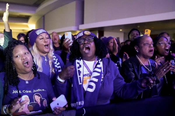 Supporters cheer during an election night watch party for Sen. Raphael Warnock, Tuesday, Dec. 6, 2022, in Atlanta. 