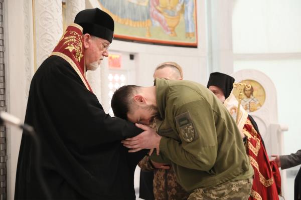 Sgt. Yuri Hundych bows his head after a brief prayer service at the St Nicholas Orthodox church.