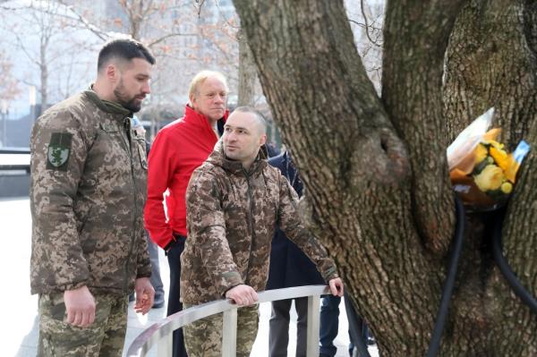 Hundych, left, and Bohuslavsky, laid a bouquet of flowers at the survivor tree touring the 9-11 Memorial with Pataki.