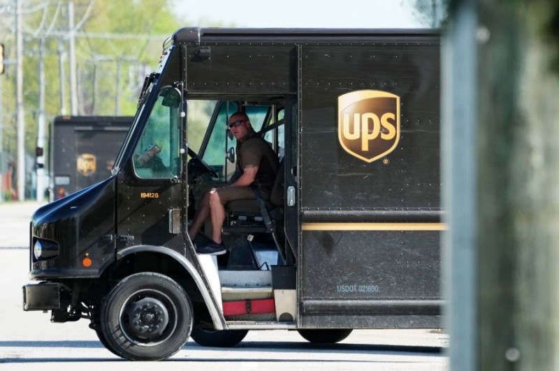 A UPS truck makes deliveries in Northbrook, Ill., Wednesday, May 10, 2023. Unio<em></em>nized UPS workers voted overwhelmingly on Friday, June 16, to authorize a strike, setting the stage for a potential work stoppage if the package delivery company and Teamsters can’t come to an agreement before their co<em></em>ntract expires next month.(AP Photo/Nam Y. Huh)