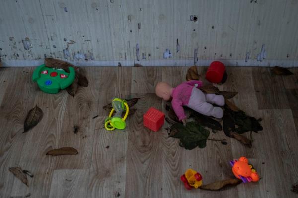 Toys and a doll lay on the floor of a playhouse in the courtyard of Kherson regio<em></em>nal children's home in Kherson, Ukraine, on Nov. 25, 2022.  