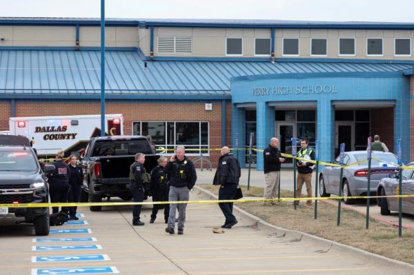 Law enforcement officers work at the scene of a shooting at Perry High School in Perry, Iowa.