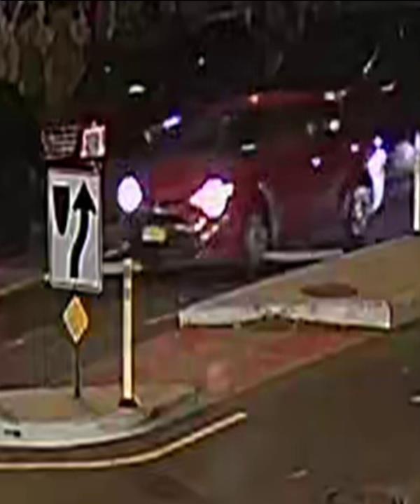 A screen grab from footage shows the red four-door sedan, which cops say was driven by the suspect in the shooting of an innocent bystander in the Bronx.
