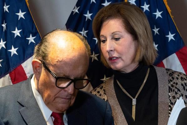 Former Mayor of New York Rudy Giuliani, left, listens to Sidney Powell, during a news co<em></em>nference at the Republican Natio<em></em>nal Committee headquarters, Thursday Nov. 19, 2020, in Washington.